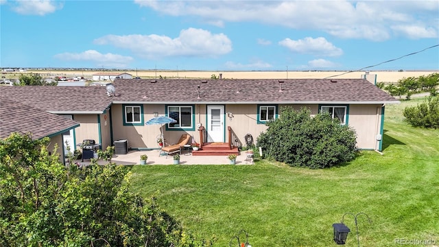 4160 Converse Rd, Bennett, CO 80102 - rear view of property featuring a patio, a lawn, and a shingled roof