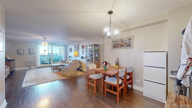 dining space featuring dark wood-type flooring and ceiling fan with notable chandelier