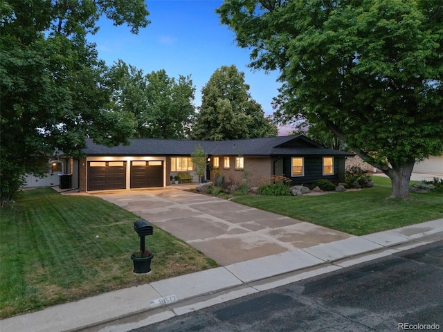 8612 W 69th Pl, Arvada, CO 80004 - ranch-style home with a garage, a front lawn, driveway, and brick siding