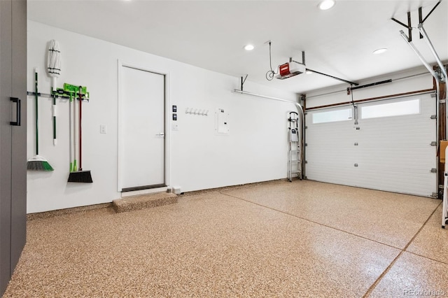 8612 W 69th Pl, Arvada, CO 80004 - garage featuring a garage door opener, recessed lighting, and electric panel