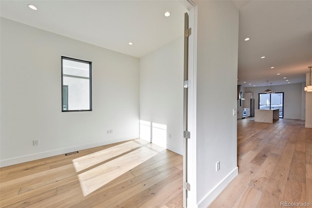 unfurnished room featuring light hardwood / wood-style floors