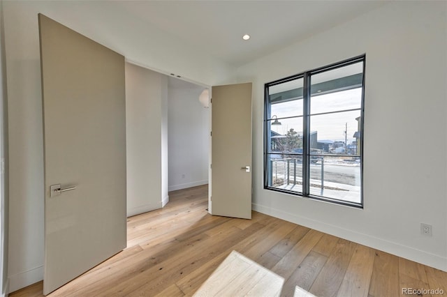 spare room featuring light hardwood / wood-style flooring