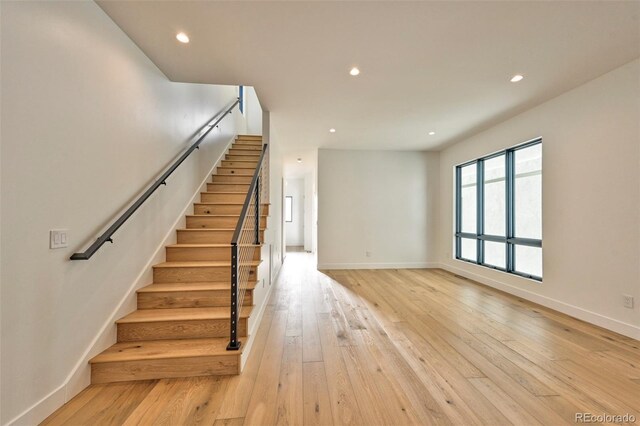 staircase with hardwood / wood-style floors