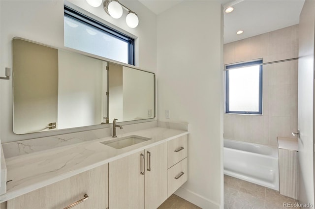 bathroom with tile patterned floors, plenty of natural light, and vanity