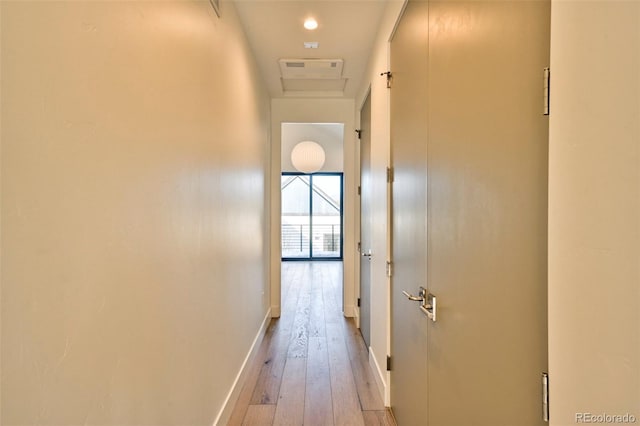 corridor with light hardwood / wood-style floors