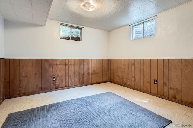 12576 W 7th Ave, Lakewood, CO 80401 - basement featuring tile patterned floors, a wainscoted wall, and wooden walls