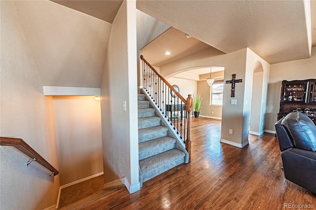 2459 Delicato Ct, Colorado Springs, CO 80921 - stairway with arched walkways, wood finished floors, baseboards, and a textured ceiling