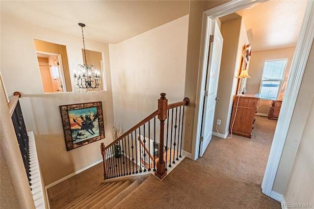 2459 Delicato Ct, Colorado Springs, CO 80921 - staircase featuring carpet floors, a chandelier, and baseboards