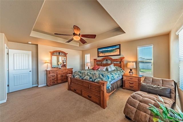 2459 Delicato Ct, Colorado Springs, CO 80921 - bedroom with a raised ceiling, light carpet, ceiling fan, and baseboards