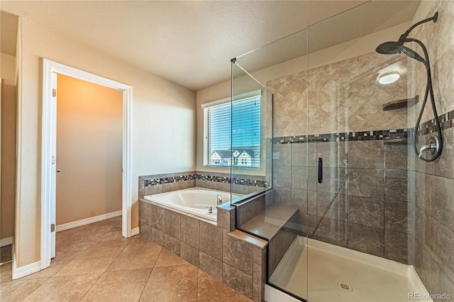 2459 Delicato Ct, Colorado Springs, CO 80921 - full bath featuring a shower stall, a bath, tile patterned flooring, and baseboards
