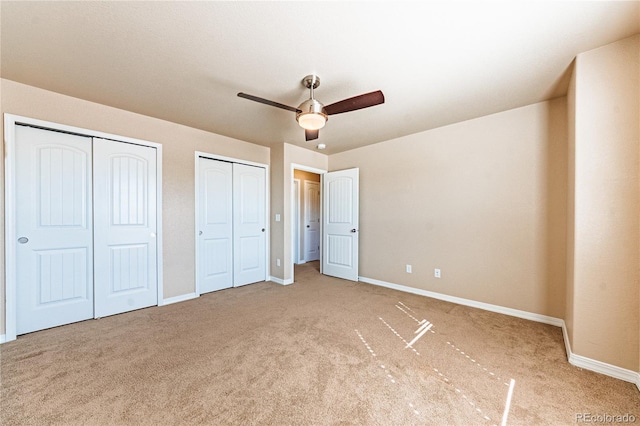 2459 Delicato Ct, Colorado Springs, CO 80921 - unfurnished bedroom with two closets, carpet floors, baseboards, and a ceiling fan