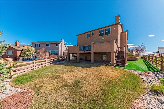 2459 Delicato Ct, Colorado Springs, CO 80921 - back of house with stairway, a wooden deck, and stucco siding