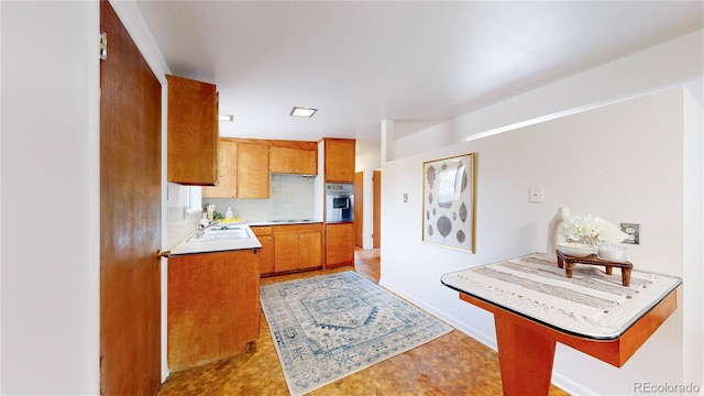 kitchen with backsplash and stainless steel oven