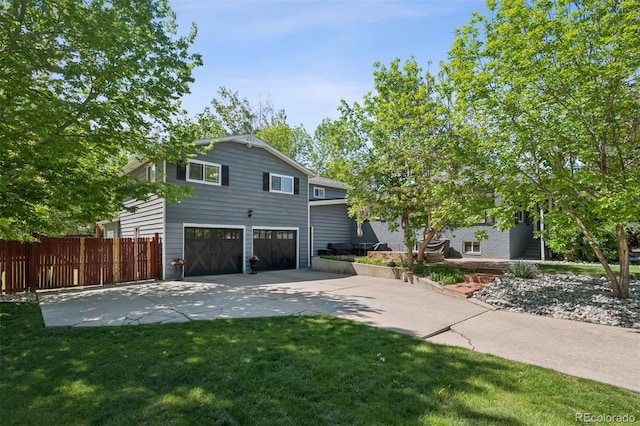 2865 Newland St, Wheat Ridge, CO 80214 - view of front of house featuring concrete driveway and a garage