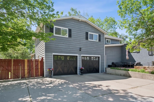 2865 Newland St, Wheat Ridge, CO 80214 - view of property exterior featuring concrete driveway and an attached garage