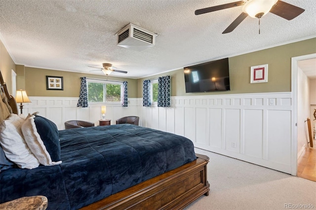 2865 Newland St, Wheat Ridge, CO 80214 - bedroom featuring wainscoting, carpet flooring, a textured ceiling, crown molding, and a ceiling fan