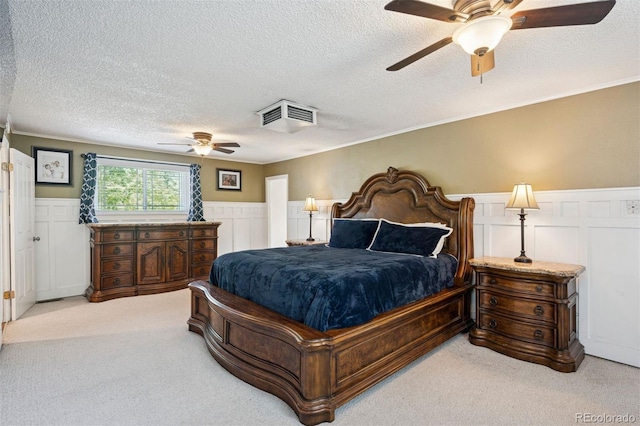2865 Newland St, Wheat Ridge, CO 80214 - carpeted bedroom with a textured ceiling, a wainscoted wall, a decorative wall, crown molding, and a ceiling fan
