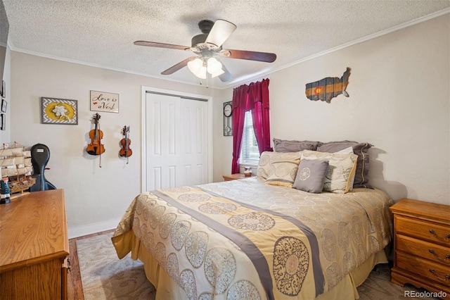 2865 Newland St, Wheat Ridge, CO 80214 - bedroom with a closet, a textured ceiling, ornamental molding, ceiling fan, and baseboards