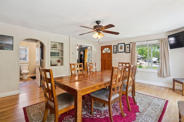 2865 Newland St, Wheat Ridge, CO 80214 - dining space featuring arched walkways, light wood-style flooring, baseboards, and a ceiling fan