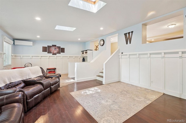 2865 Newland St, Wheat Ridge, CO 80214 - living area with an AC wall unit, wood finished floors, a skylight, recessed lighting, and stairway