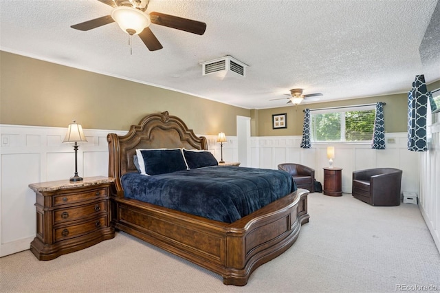 2865 Newland St, Wheat Ridge, CO 80214 - carpeted bedroom with a textured ceiling, wainscoting, a decorative wall, and a ceiling fan