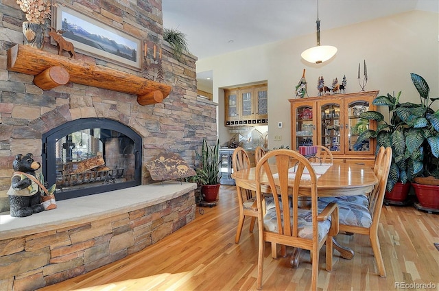 dining space with lofted ceiling and light wood-type flooring