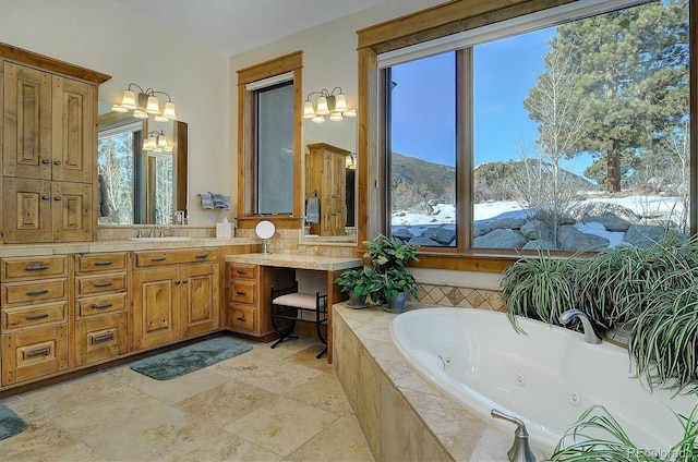 bathroom featuring vanity, a mountain view, and tiled bath