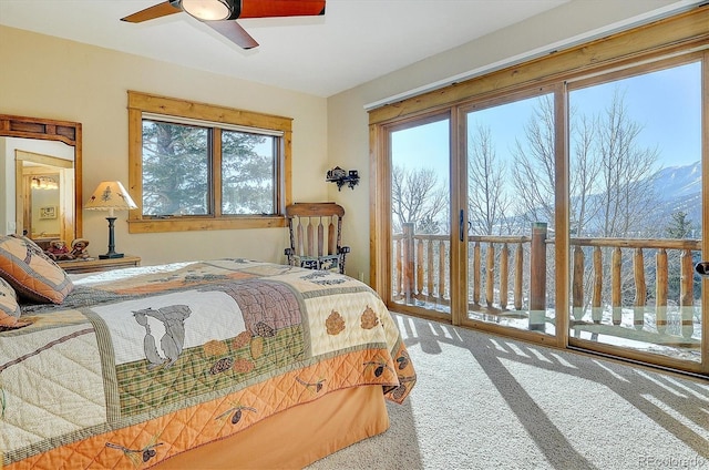 carpeted bedroom featuring access to exterior and ceiling fan