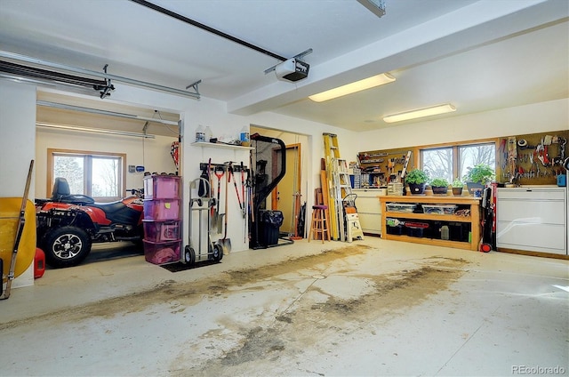 garage with a garage door opener and a workshop area