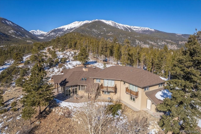 snowy aerial view with a mountain view