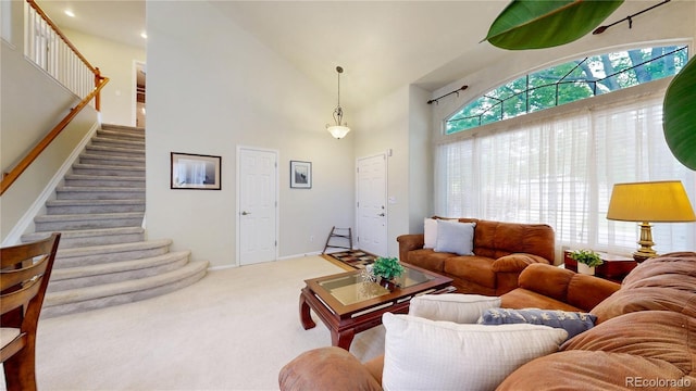13307 Humboldt Dr, Thornton, CO 80241 - carpeted living room with stairs, a high ceiling, and baseboards