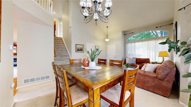 13307 Humboldt Dr, Thornton, CO 80241 - carpeted dining space featuring stairs, a towering ceiling, a chandelier, and baseboards