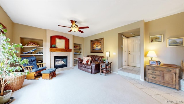 13307 Humboldt Dr, Thornton, CO 80241 - living room featuring a glass covered fireplace, light colored carpet, a ceiling fan, built in features, and baseboards