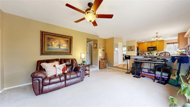 13307 Humboldt Dr, Thornton, CO 80241 - living room with light colored carpet, a chandelier, ceiling fan, and baseboards