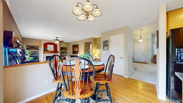13307 Humboldt Dr, Thornton, CO 80241 - dining space with a chandelier, light wood-style flooring, a tile fireplace, and baseboards