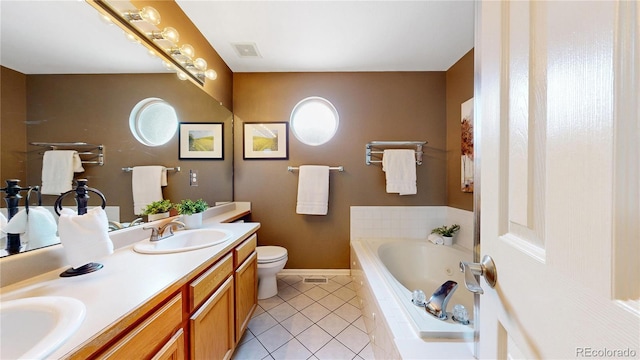 13307 Humboldt Dr, Thornton, CO 80241 - bathroom featuring tile patterned floors, a bath, baseboards, double vanity, and toilet