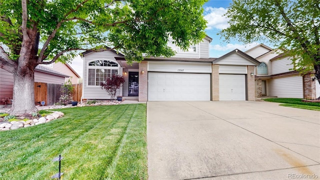 13307 Humboldt Dr, Thornton, CO 80241 - view of front of house with concrete driveway, brick siding, and an attached garage