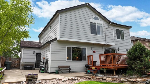 13307 Humboldt Dr, Thornton, CO 80241 - back of house featuring a deck, a patio, and a gate