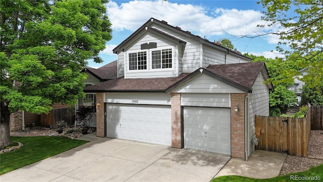 13307 Humboldt Dr, Thornton, CO 80241 - traditional home with brick siding, a shingled roof, and an attached garage