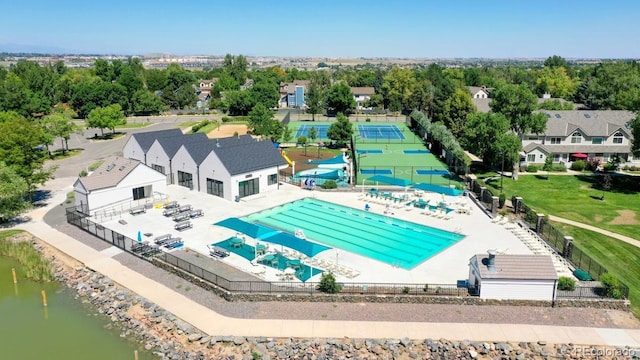 13307 Humboldt Dr, Thornton, CO 80241 - drone / aerial view of a pool area, a nearby body of water, and a tree filled landscape