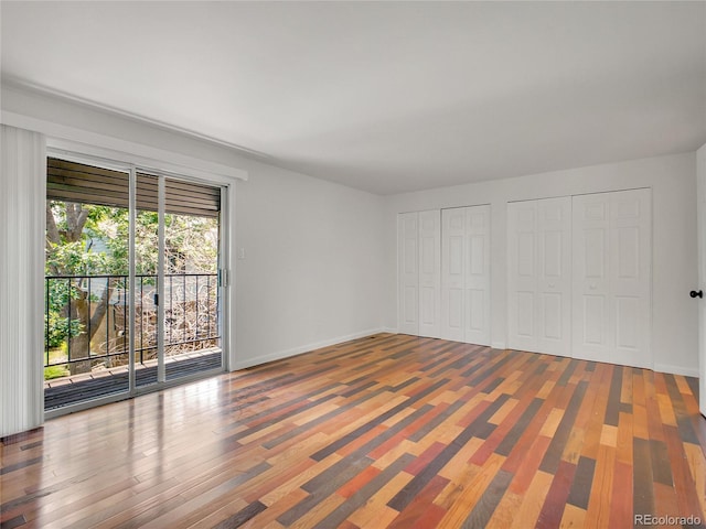 3061 W 92nd Ave Unit 14A, Westminster, CO 80031 - unfurnished bedroom featuring access to outside, two closets, and wood finished floors