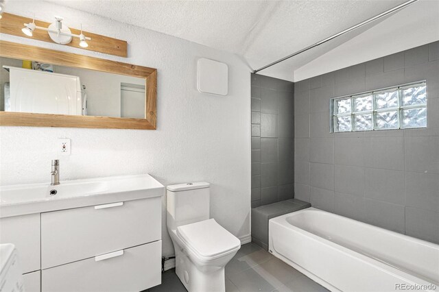 full bathroom featuring vanity, lofted ceiling, tile patterned flooring, toilet, and a textured ceiling