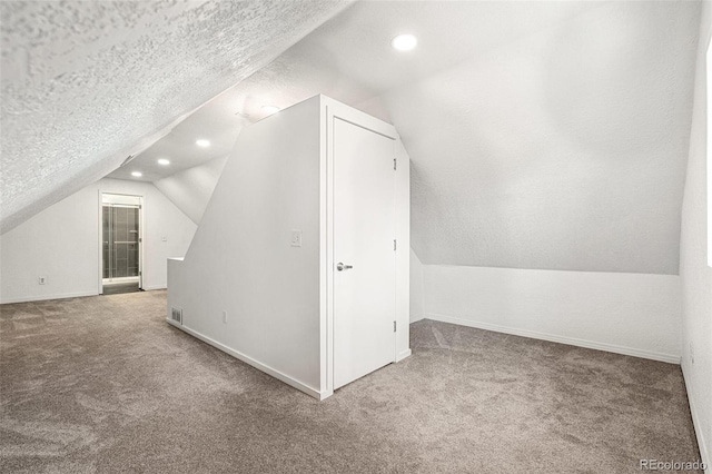 bonus room with carpet floors, lofted ceiling, baseboards, a textured ceiling, and recessed lighting