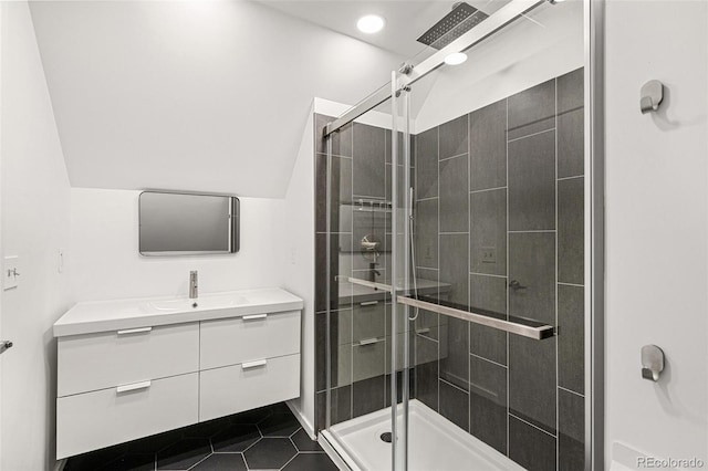 bathroom with a stall shower, vanity, and recessed lighting