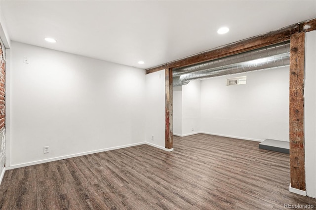 finished below grade area featuring wood finished floors, baseboards, and recessed lighting