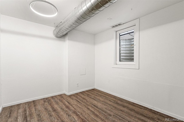 spare room with wood finished floors and baseboards