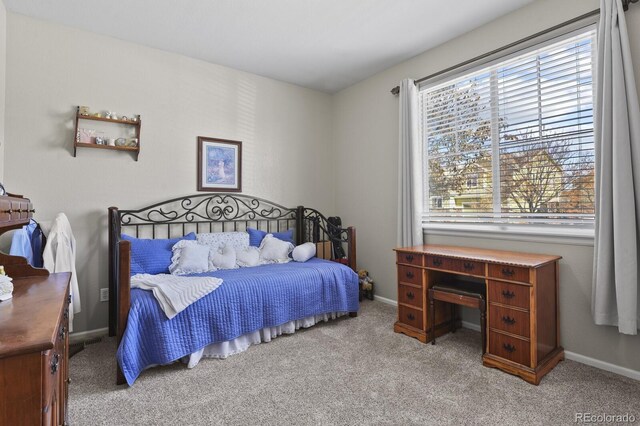 bedroom featuring carpet and baseboards