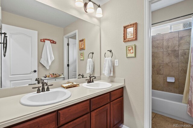 full bathroom featuring tile patterned floors, double vanity, shower / bathtub combination with curtain, and a sink