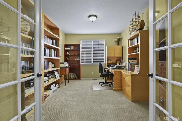 carpeted office space featuring french doors