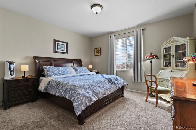 bedroom featuring baseboards and light carpet